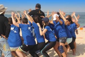 seat on circle games, beach team building, expedia group