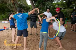 Hula Hoop Transfer Game on Beach Team Building - Aurecon Group hula hoop transfer, aurecon, aurecon group, beach team building, bali team buidling, incentive trip to bali
