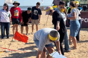 Participants working together during GBPN Indonesia beach team building competition