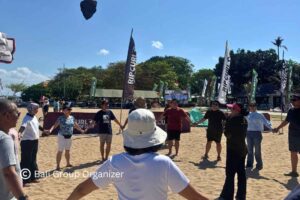 GBPN Indonesia group joining a warm-up activity before beach team building games